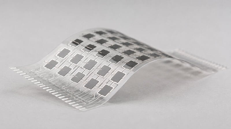 Flexible curved sensor film with a grid array of conductive-silicone sensor pads